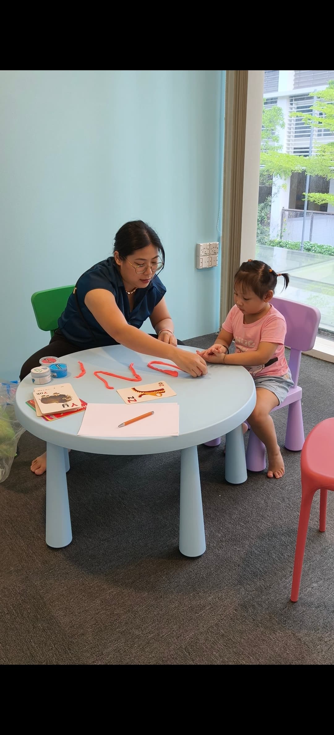 Therapist interacting with child using instruments